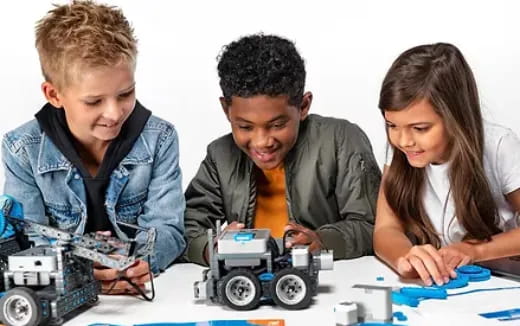 a group of kids playing with toy cars