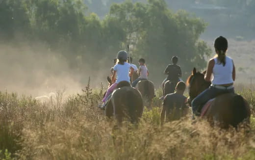 a group of people riding horses