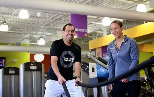 a man and a woman standing next to a machine