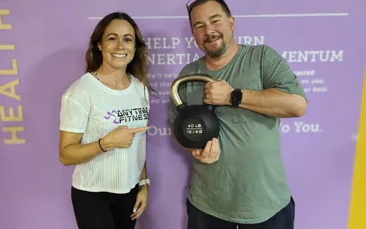 a man and a woman holding a helmet