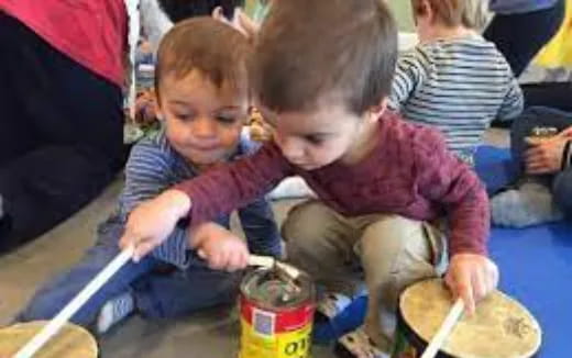 a few children playing with a bucket