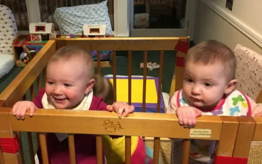 two babies sitting at a table