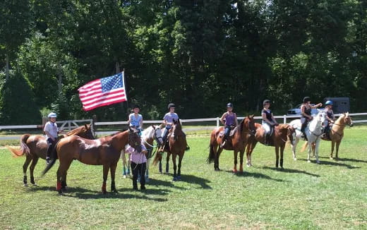 a group of people riding horses