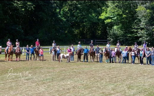 a group of people standing on horses