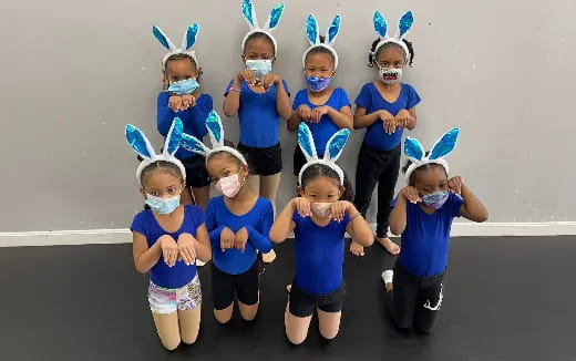 a group of children wearing blue and white clothing
