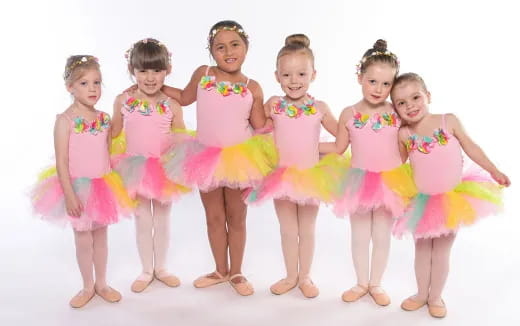 a group of girls in dresses