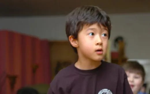 a boy in a purple shirt