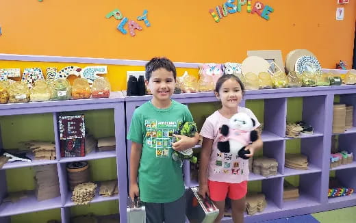 a boy and girl posing for a picture in a store