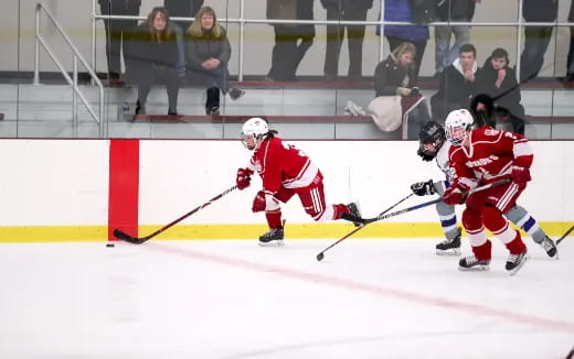 a group of people playing hockey