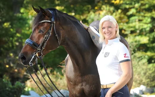 a person standing next to a horse