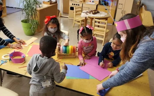 a group of children sitting around a table