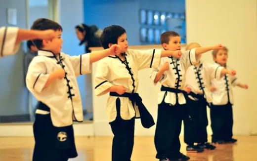 a group of children in karate uniforms