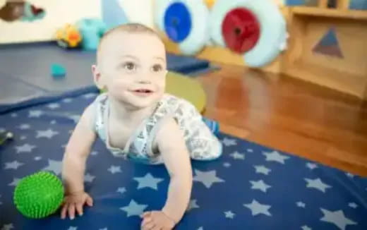 a baby lying on a blue blanket