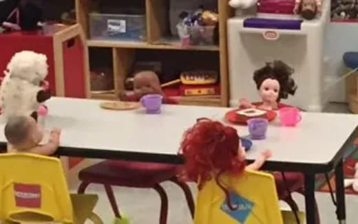 a group of children sitting at a table