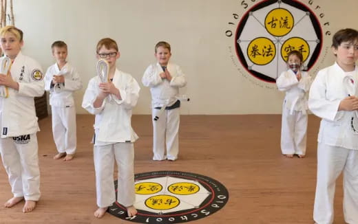 a group of kids in karate uniforms
