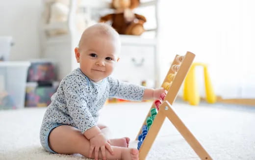 a baby holding a toy sword