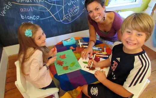 a group of children sitting at a table