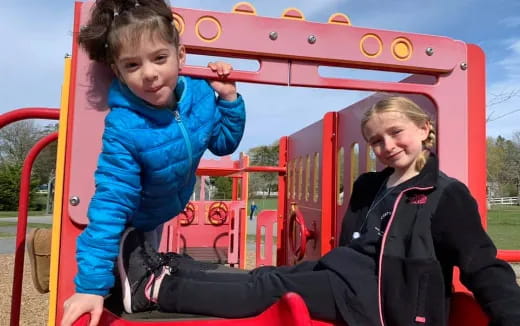 a person and a child on a playground ride