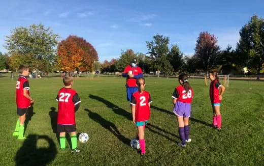 a group of kids playing football