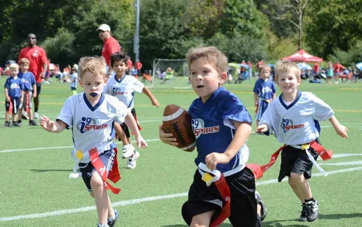 a group of kids playing football