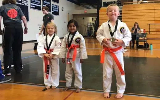 a group of girls in karate uniforms