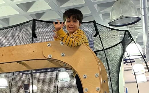 a boy in a yellow shirt