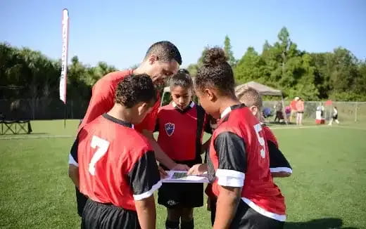 a group of boys in red shirts
