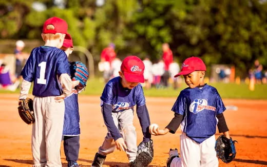 kids playing baseball on a field