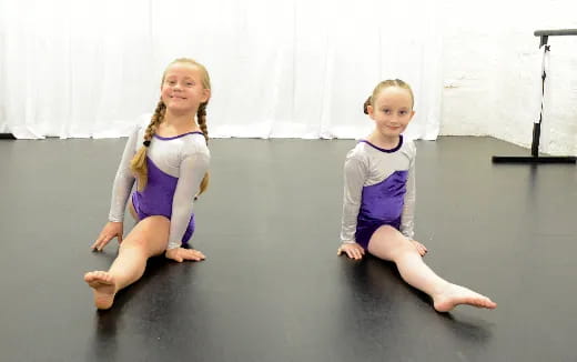 two children sitting on the floor