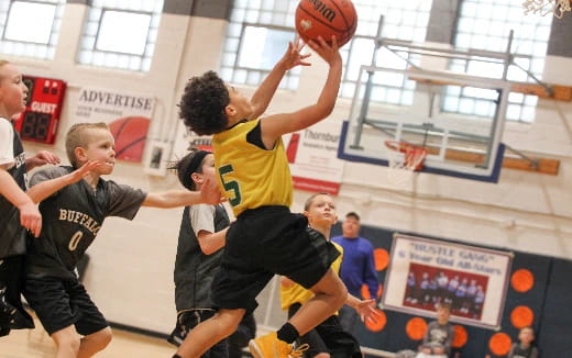 a group of people playing basketball