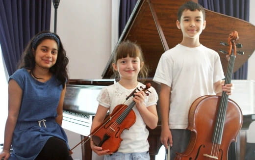 a group of kids holding musical instruments