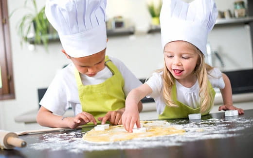 a person and a girl wearing chef hats