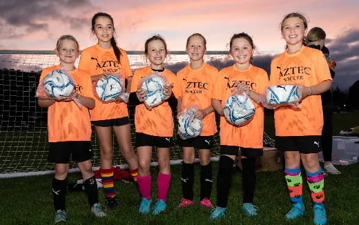a group of girls in football uniforms