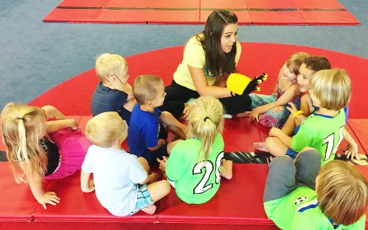a person and several children sitting on the floor