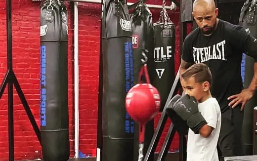 a man and a boy in a boxing ring