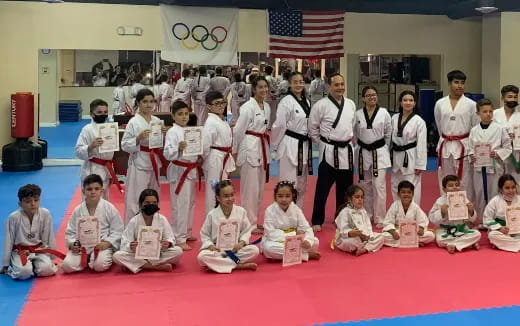 a group of children in karate uniforms