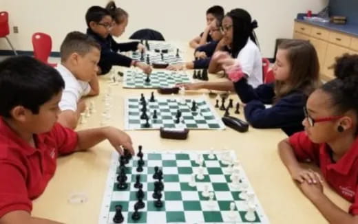 a group of children playing chess