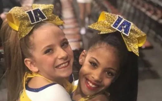 a couple of girls wearing yellow and blue hats