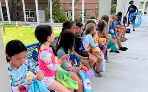 a group of children sitting on the ground