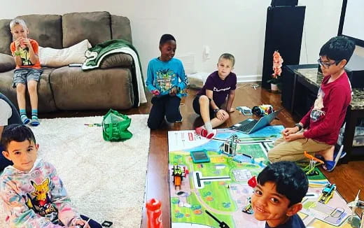 a group of children sitting around a table