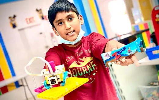 a young boy holding a toy