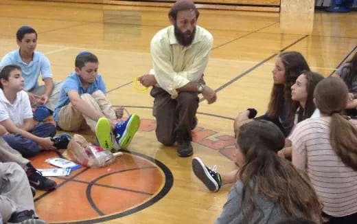 a person standing in front of a group of children