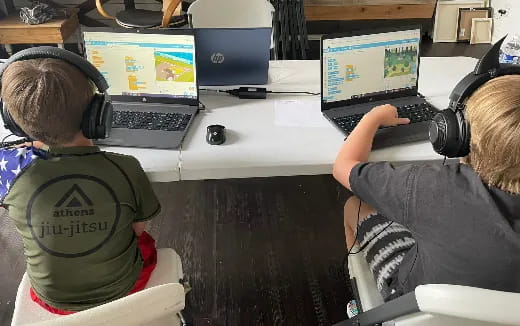 a couple of people using laptops