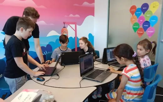 a group of people using laptops
