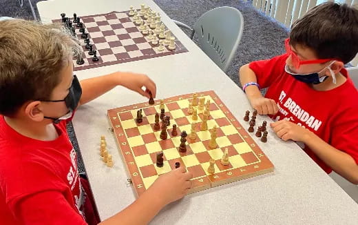 a group of boys playing chess