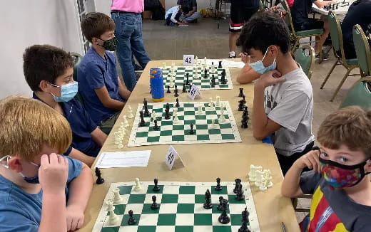 a group of children playing chess