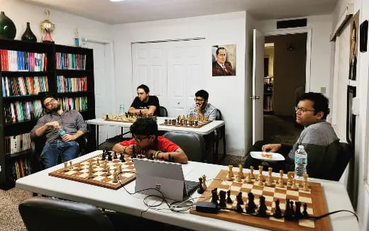 a group of people playing chess