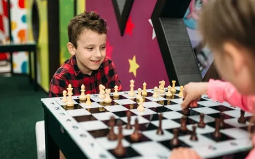 a couple of kids playing chess