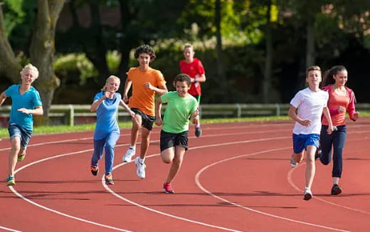 a group of people running on a track