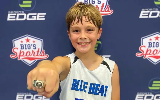 a boy holding a silver medal